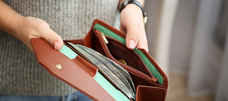 Girl with brown wallet full of money